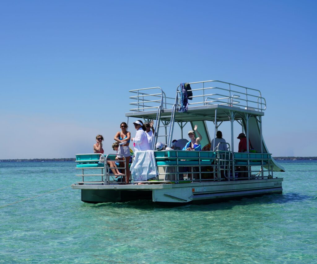 Double decker pontoon boat with an upper deck and water slide at Crab Island, Destin